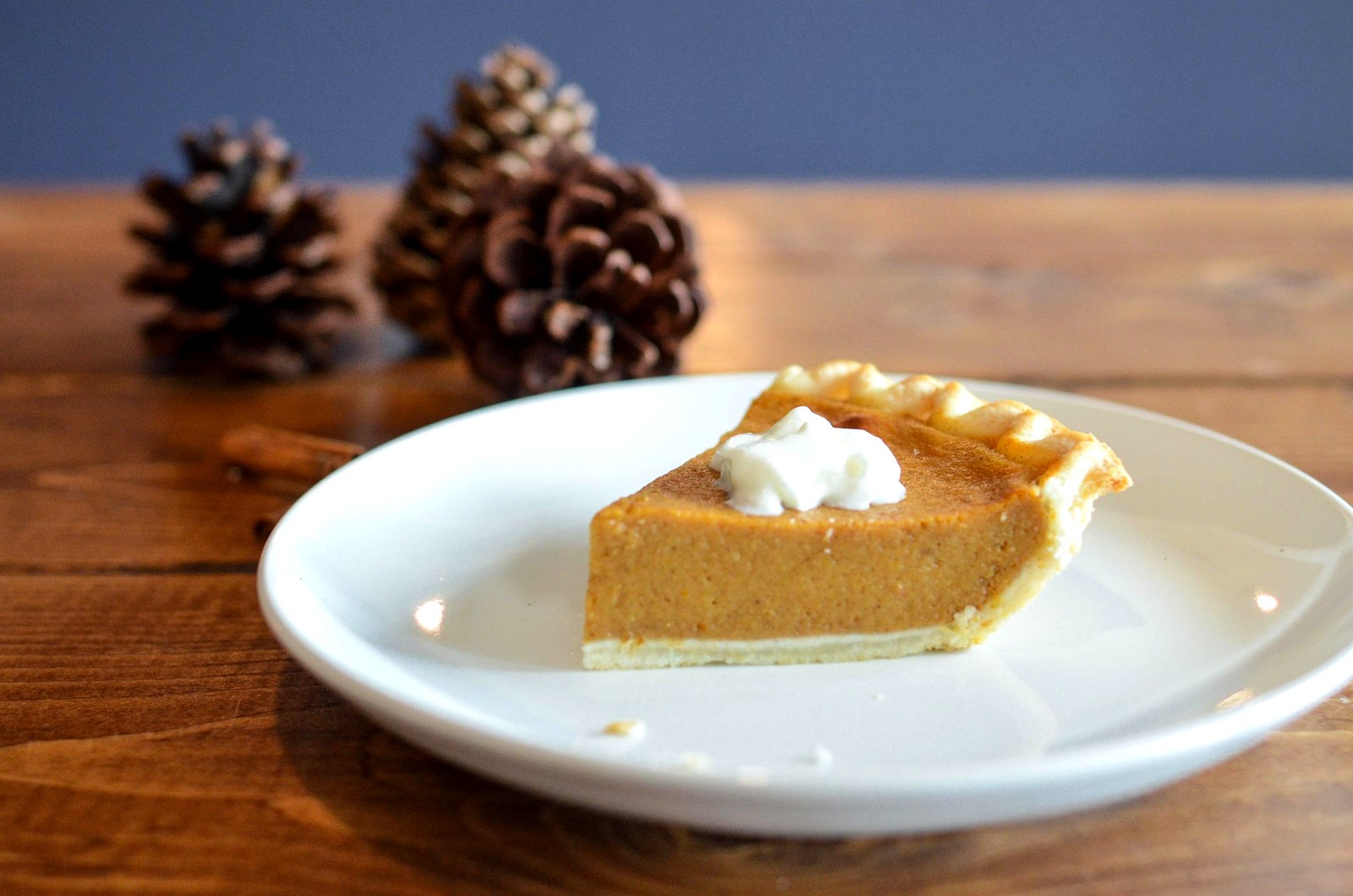 Close-up slice of pumpkin dump cake topped with whipped cream